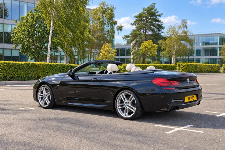 Rear three-quarter, passenger side, roof down